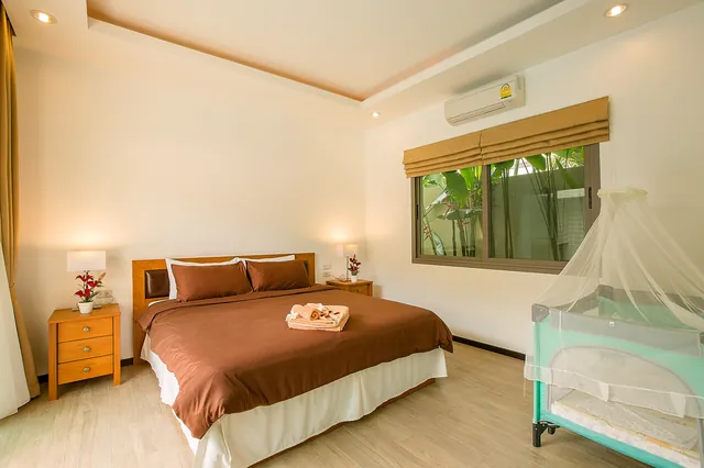 Bedroom with baby cot and canopy