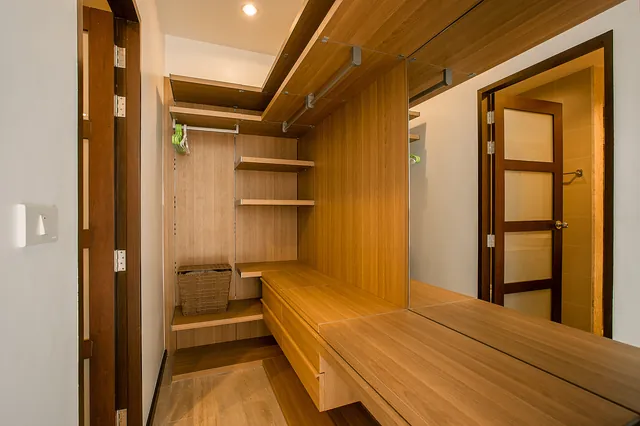 Walk-in wardrobe with wooden shelving